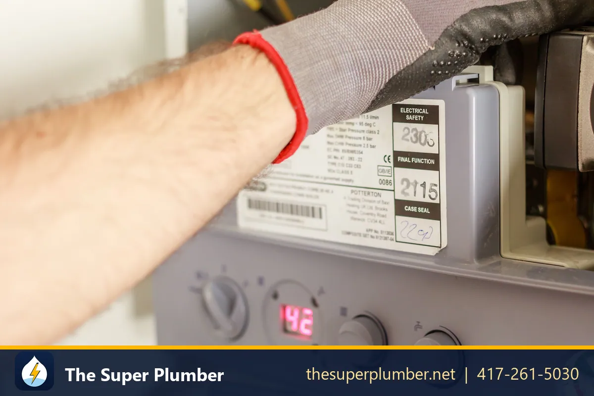 Gloved hands working on a circulator pump and its digital controls - Plano plumbing repair