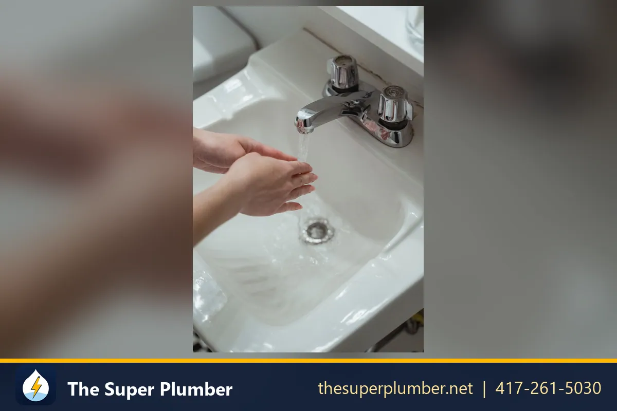 Water flowing down a chrome basin drain - plumber in Washington
