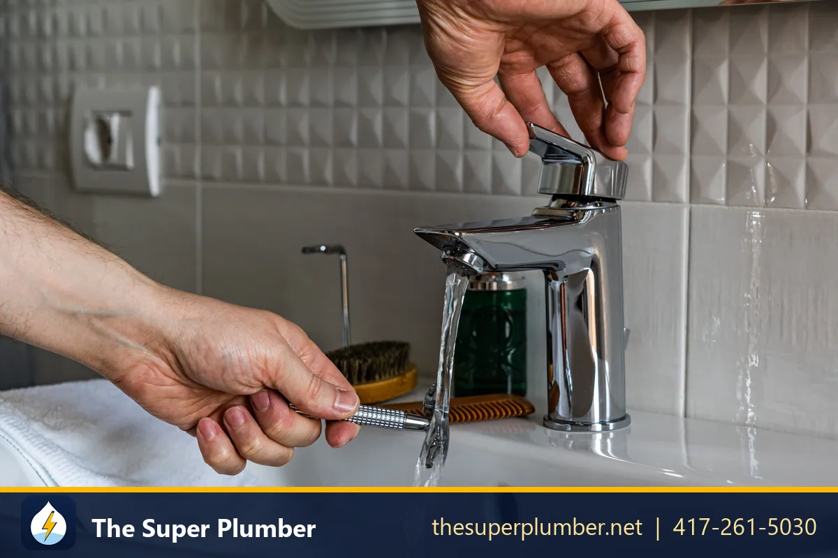 Hands tightening a chrome mixer tap with a small tool while water runs - gas plumbing: gas lines & gas leak detection